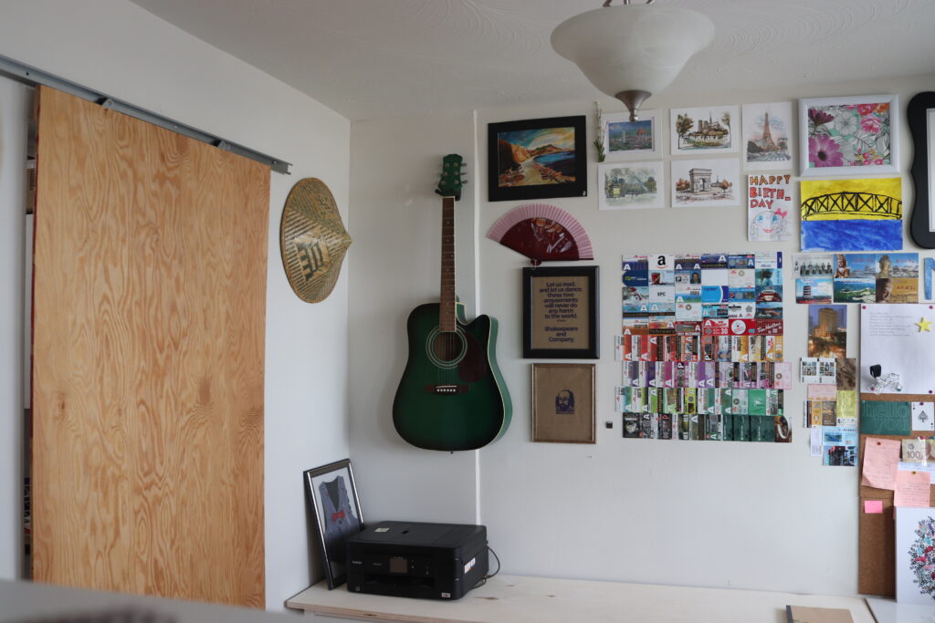Sliding door in home office, guiter and paintings on the wall