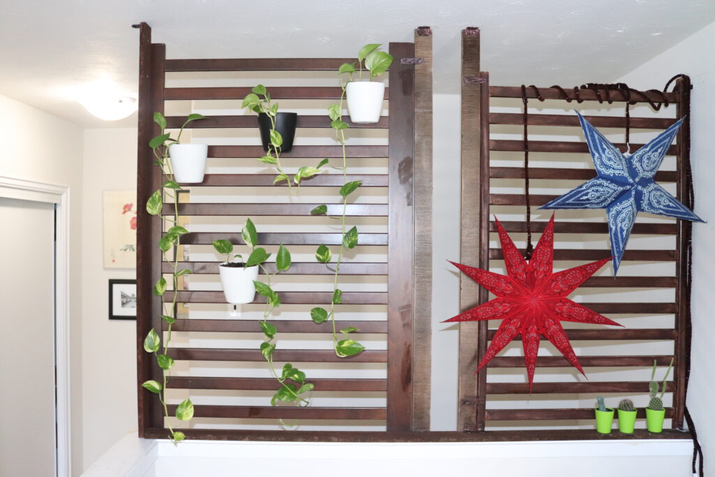 DIY wooden wall with plant and lantern hanging